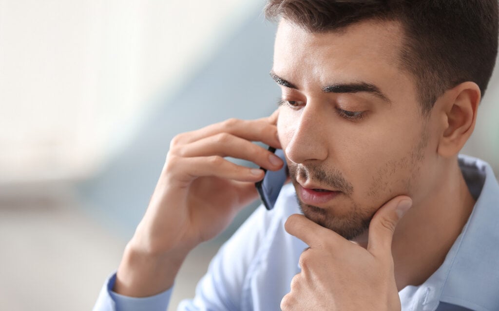 a man on the phone with a loan agency