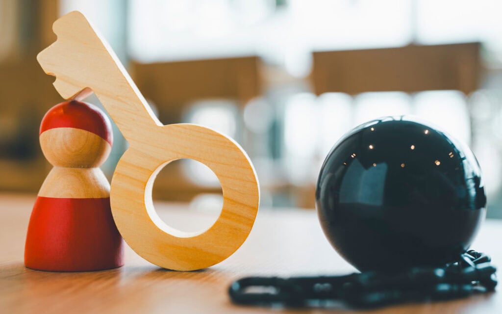 a wooden key and small figurine