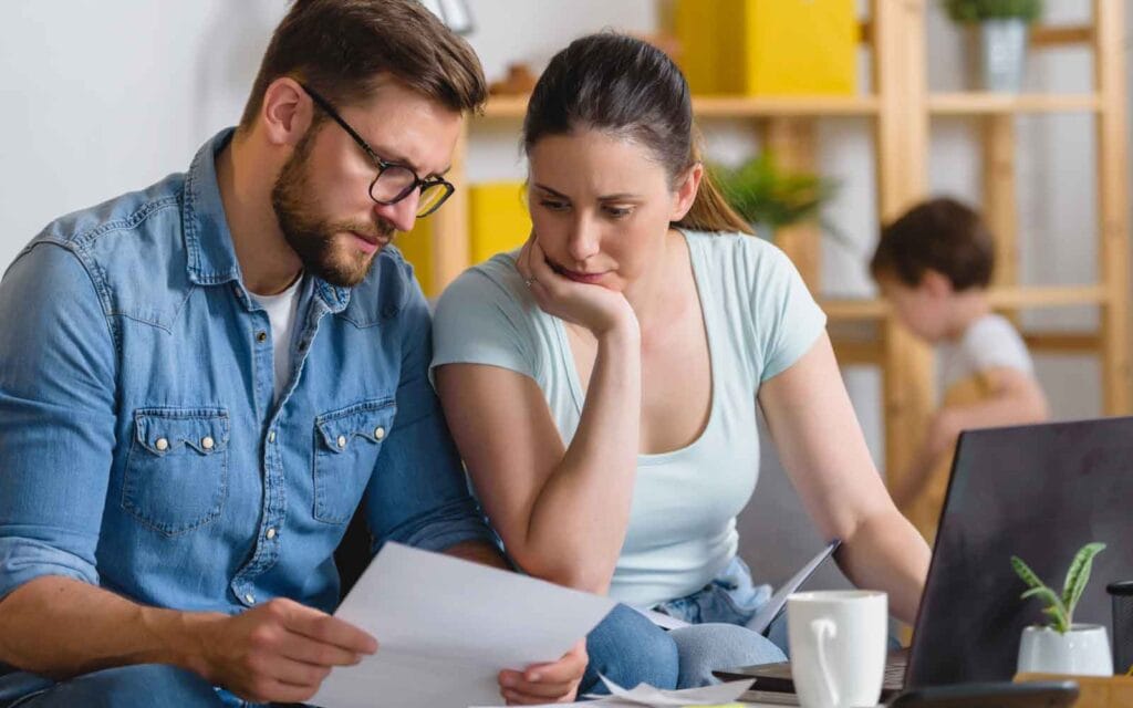 a concerned couple reviewing their finances