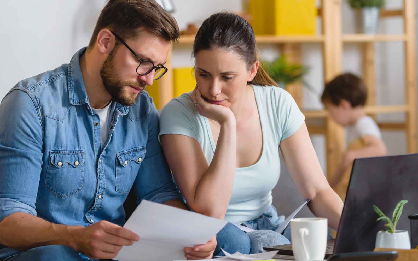 a concerned couple reviewing their finances