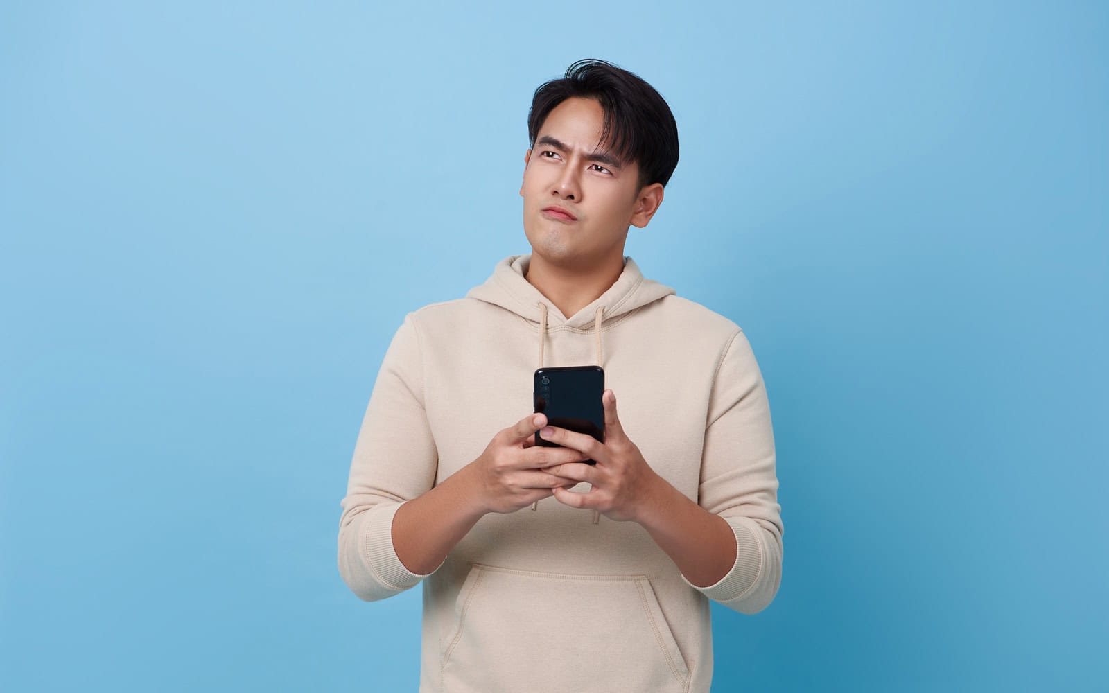 Man thinking about taking out a $500 Loan on a blue back ground