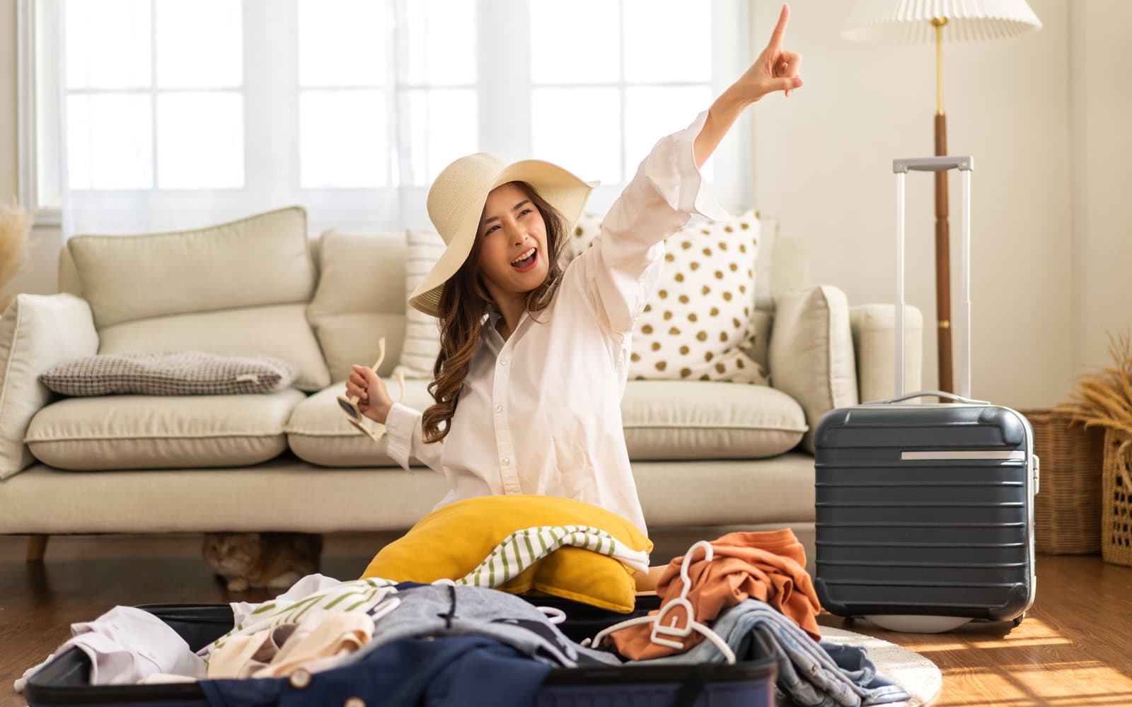 Happy woman packing for a weekend trip with the help of a quick Auckland Loans.