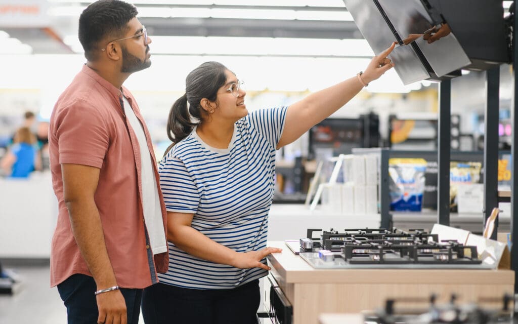 Everyday couple shopping for a new appliance thanks to flexible weekend loan options form Auckland Loans.